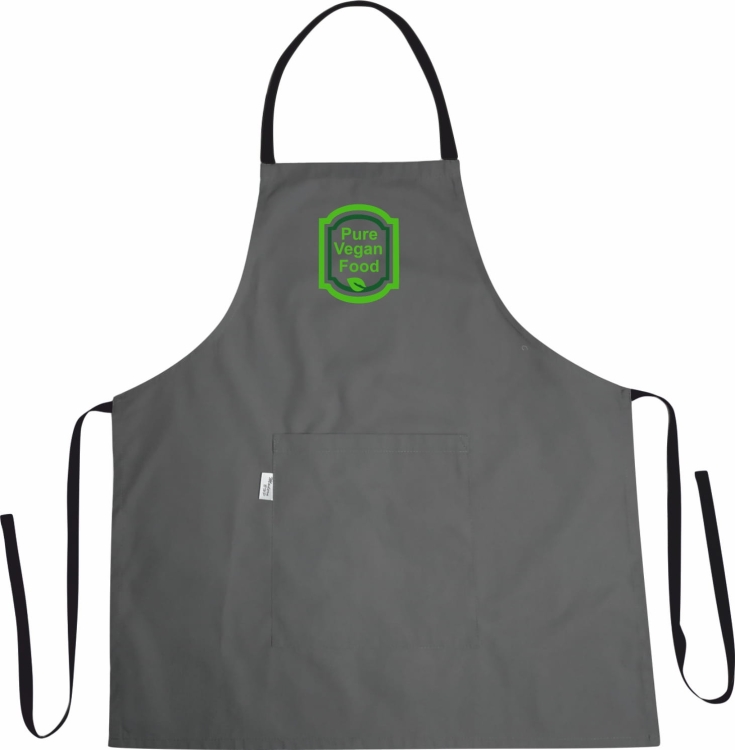 Tablier de cuisine avec le logo 'Pure vegan food' en arrière-plan de la cuisine.